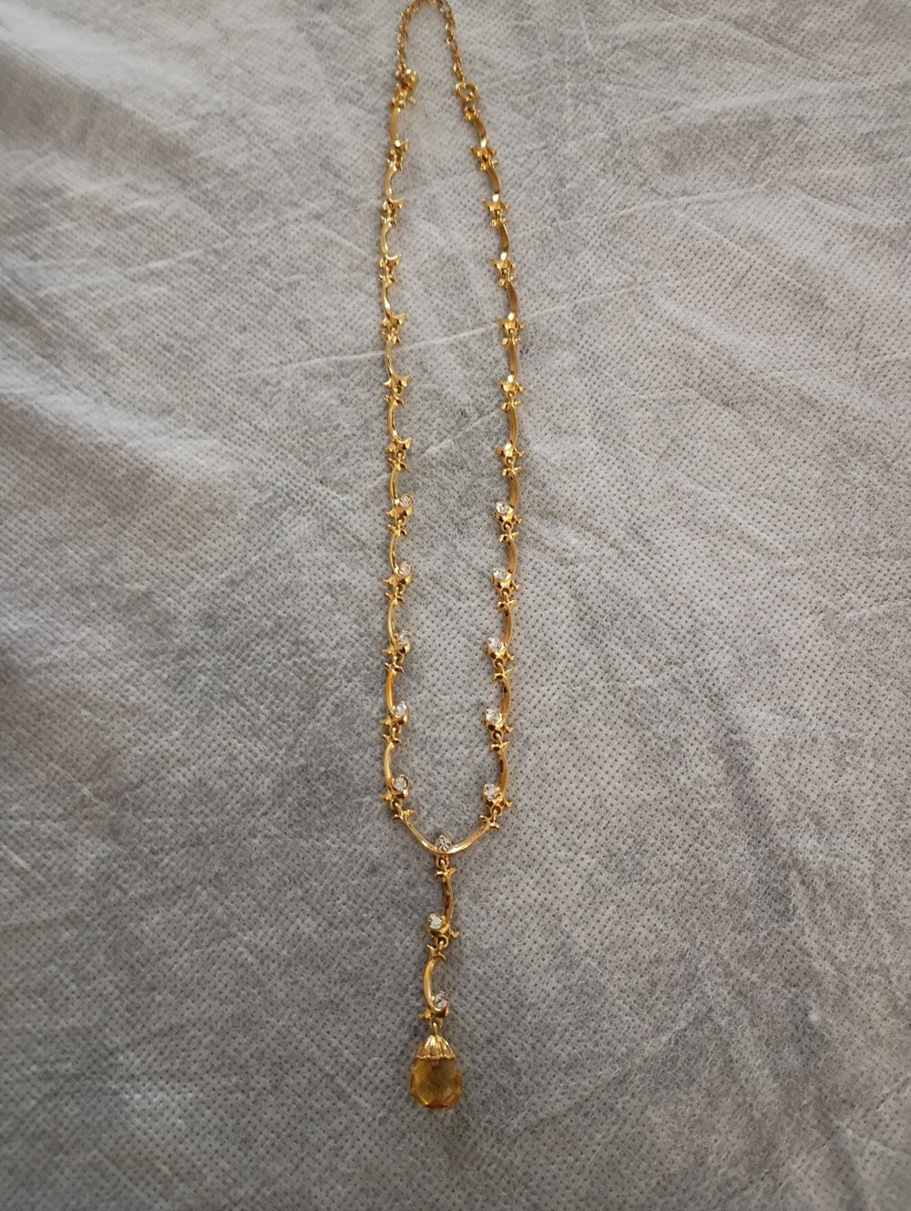 AVON GOLDEN CRYSTAL TEAR DROP WITH CLEAR CRYSTAL ACCENTS.